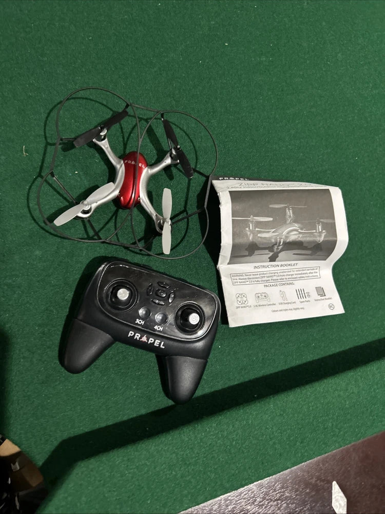 Propel helicopter drone with black remote controller and white instruction sheet