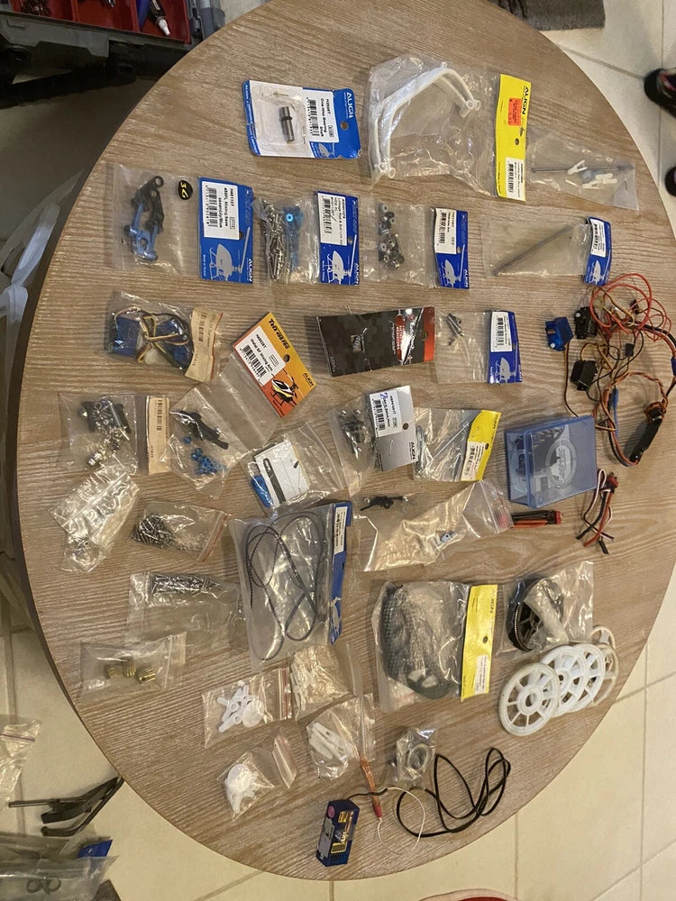 Remote control helicopter drone parts lot with assorted cables, motors, and spare hardware