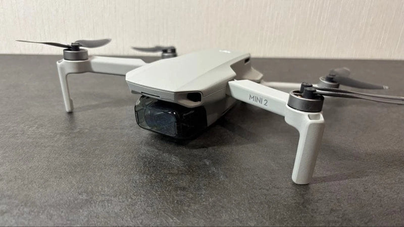 DJI Mini 2 drone with camera, gray, front view with propellers