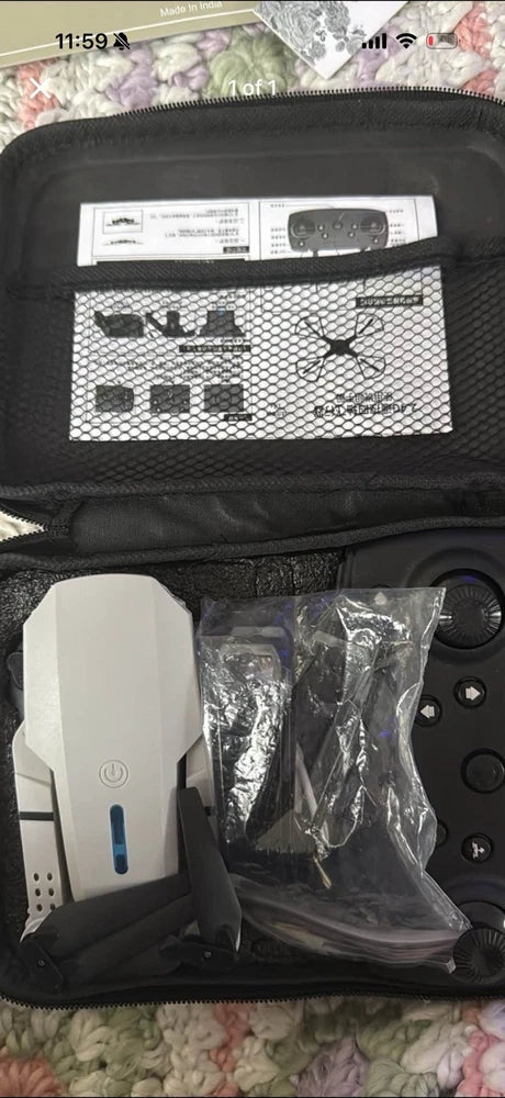 Toy quadcopter drone kit with controller and parts in open black carrying case