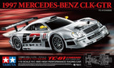 Silver and black RC race car model kit with detailed body and wheels, front 3/4 view
