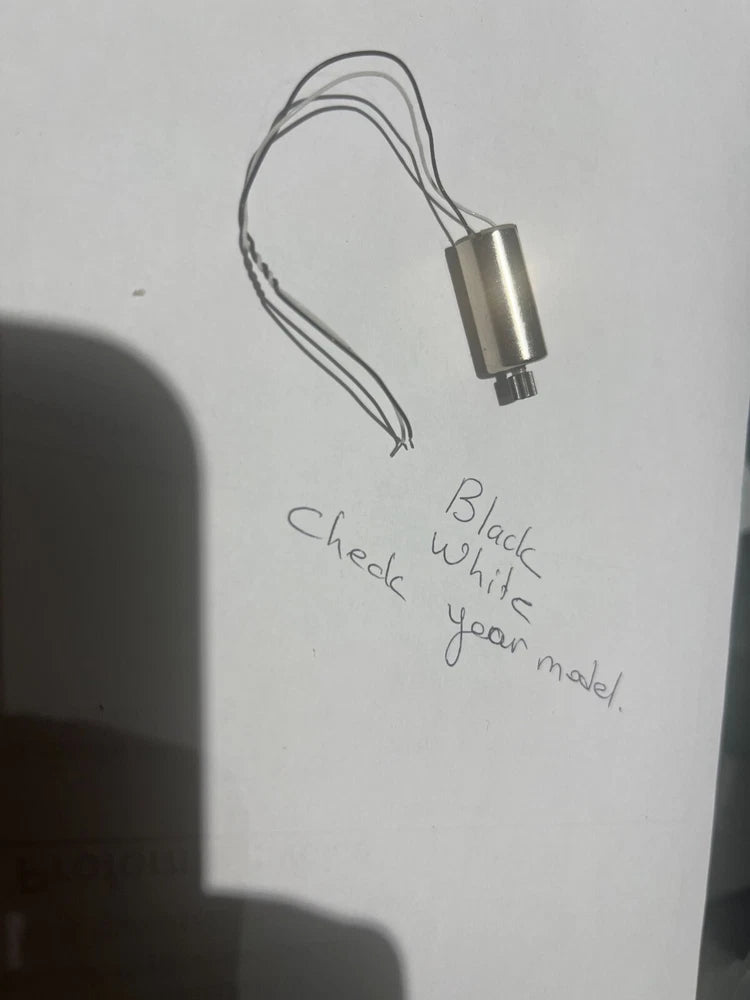 Replacement FPV drone motor with attached wires, black and white leads, silver body