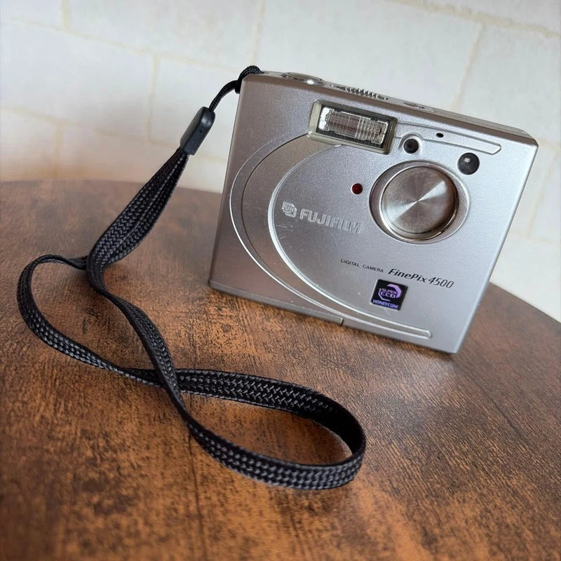 Vintage Fujifilm FinePix 4500 compact digital camera with strap, silver-gray body and flash