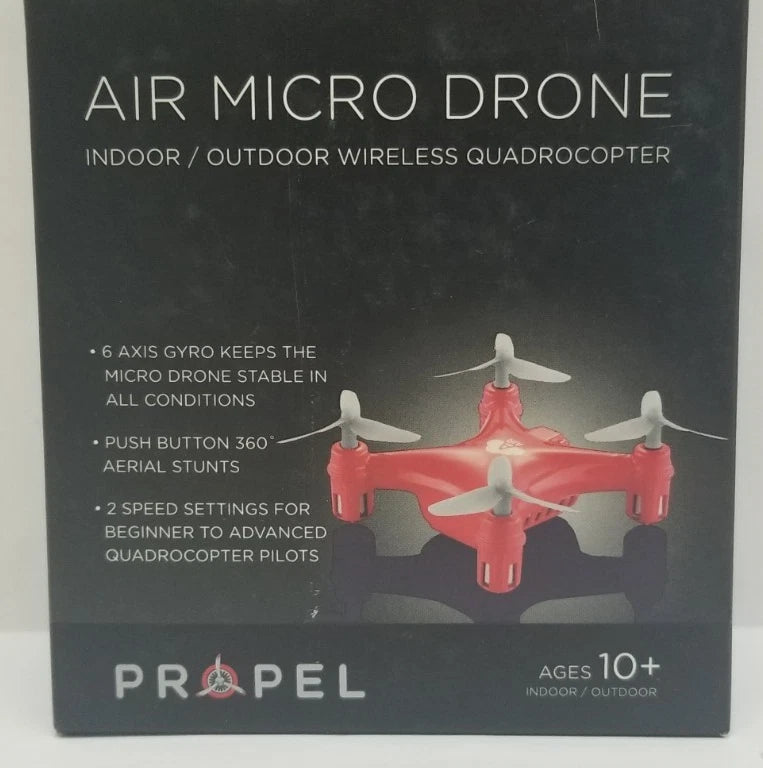 Red quadcopter micro drone with four propellers on product box