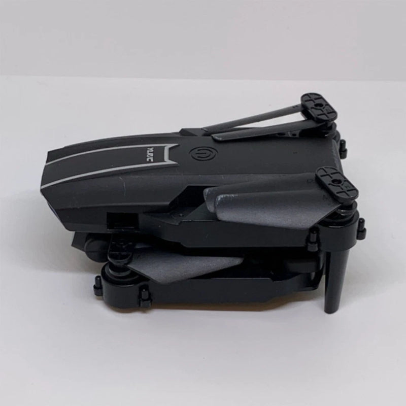 Black foldable quadcopter drone with front arms and propellers raised