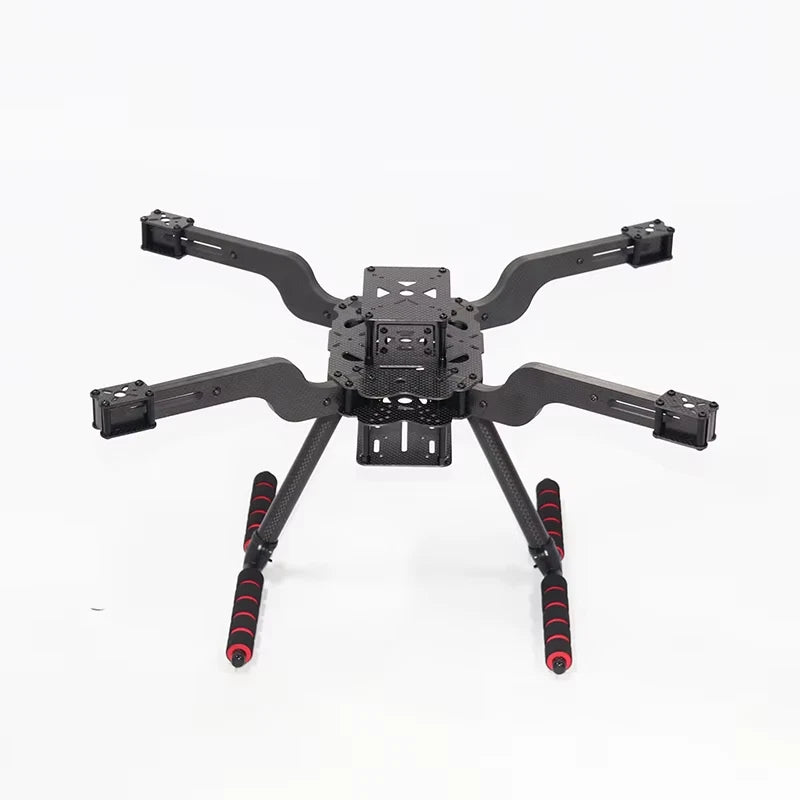 Quadcopter drone frame with four arms, central controller plate, and red antennas