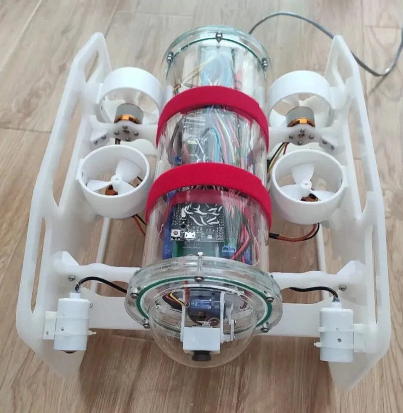 Underwater ROV robot diver with clear dome, red ring accents, and white thruster arms