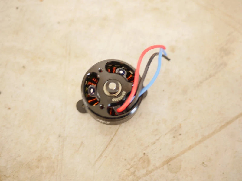 Electric drone motor, round stator with red and blue wires and copper windings