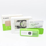Green waterproof Canon iNSPiC REC FV-100 camera in clear protective case, with box