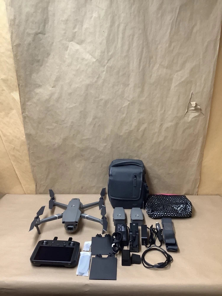 DJI Mavic Pro 2 drone with controller, battery, and accessory cables laid out