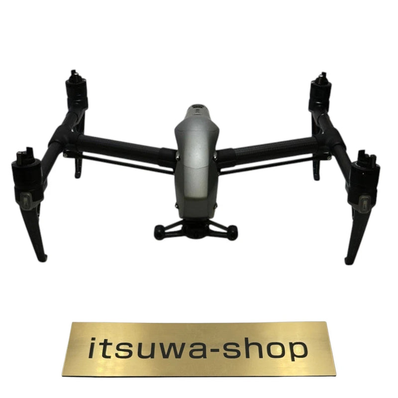 Gray and black quadcopter drone with four extended propellers and central body
