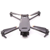 Gray DJI Mavic drone with four propeller arms extended and front camera gimbal