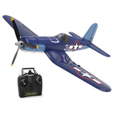 Blue RC warbird airplane with propeller and remote transmitter