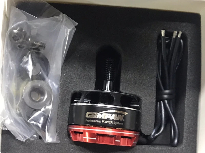 Brushless drone motor with red/black casing, wires, and mounting screws