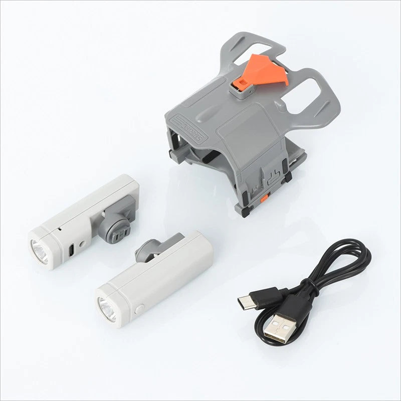 Drone searchlight accessory kit with two white lights, mounting bracket, and USB cable