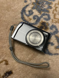 Fujifilm FinePix F45 FD digital camera, silver and black body with lens and strap