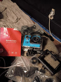 Action sports camera with waterproof housing and mount, blue accents and front lens