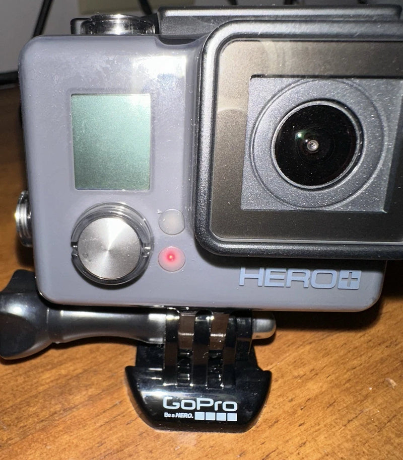 Gray GoPro HERO+ action camera with front lens, LCD screen, and mounting base