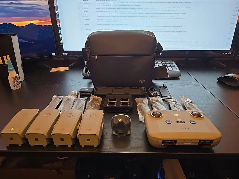 Brown zippered case with beige controller and spare battery packs