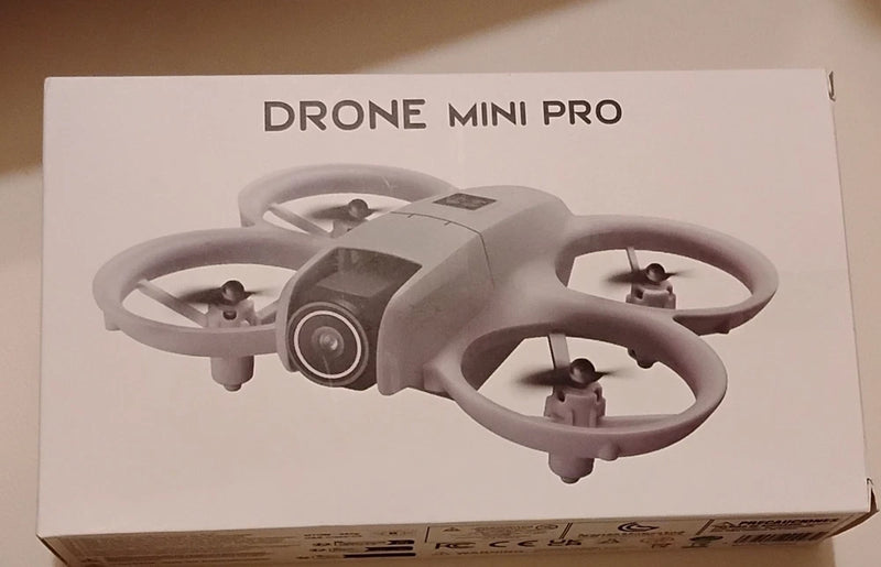 Grey mini quadcopter drone on retail box, four propellers