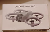 Grey mini quadcopter drone on retail box, four propellers