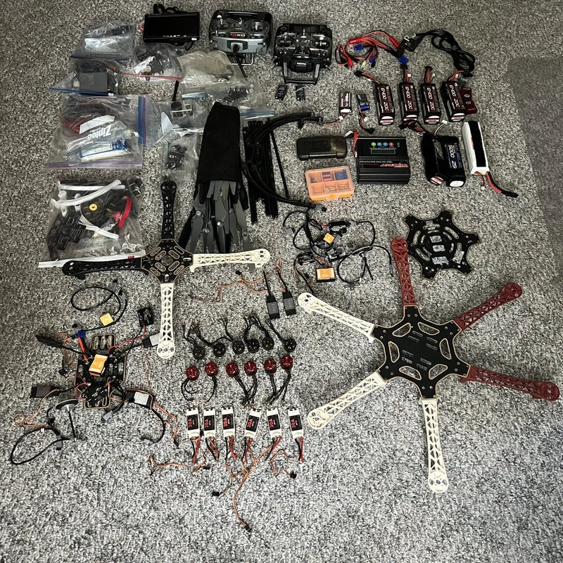 DJI multirotor drone parts kit with propellers, frames, wiring, and remote accessories