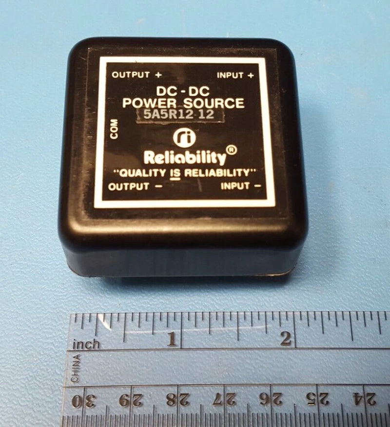 DC-DC power converter module with label, shows input and output terminals and 12V rating