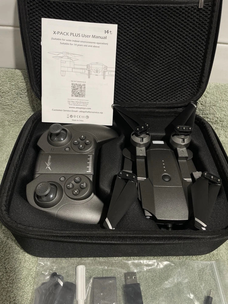 Foldable quadcopter drone kit in hard case with controller and folded rotors
