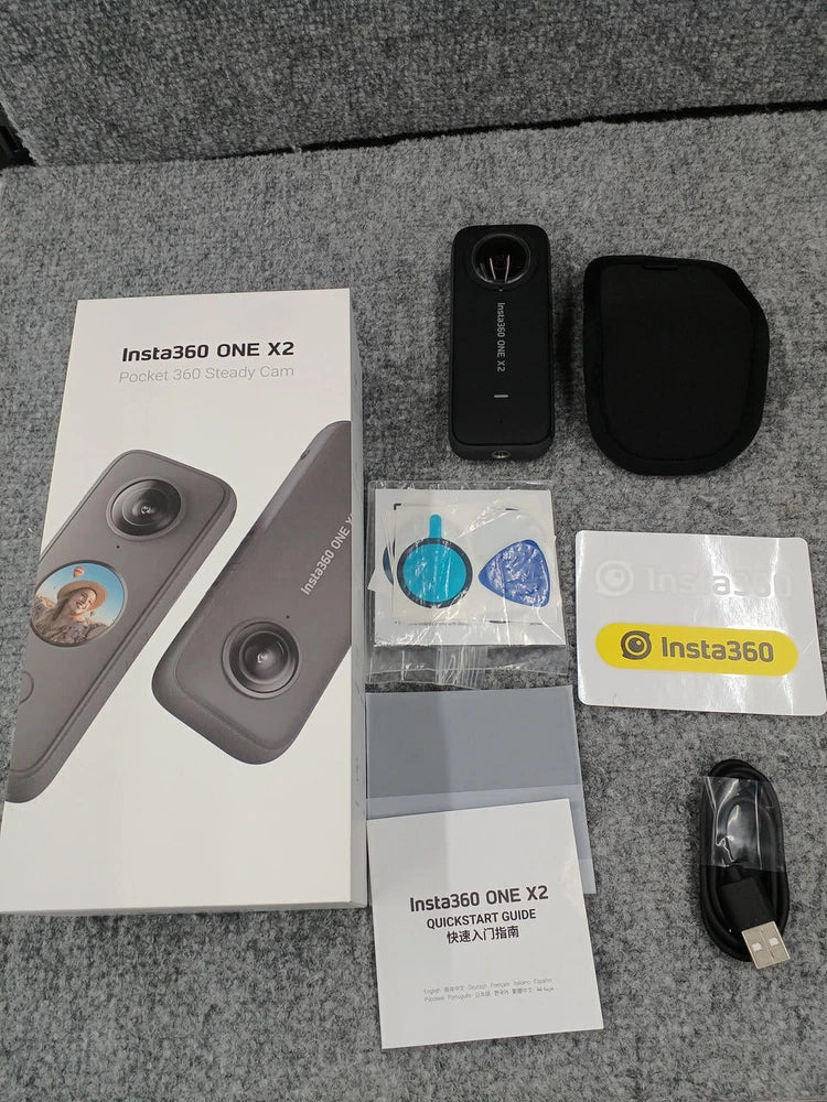 Insta360 ONE X2 digital pocket camera with gray camera, black case, cable, and manuals