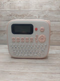 Pink handheld label maker with screen, print button, and letter keyboard