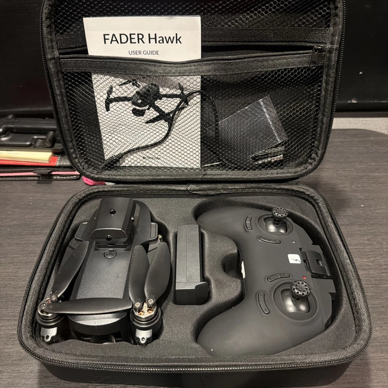Foldable quadcopter drone and controller in black hard case, accessories shown