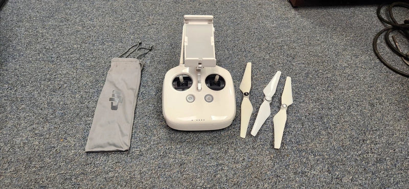 White drone remote transmitter with antenna, plus storage pouch and spare blades