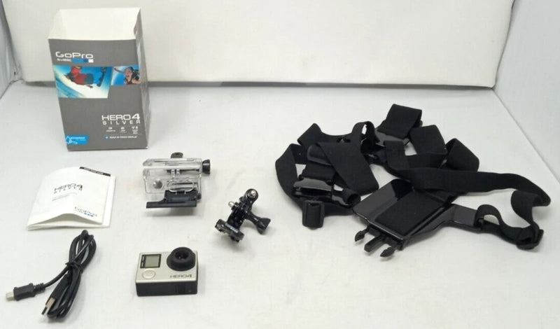 GoPro HERO4 action camera with mounting accessories, silver camera and black straps