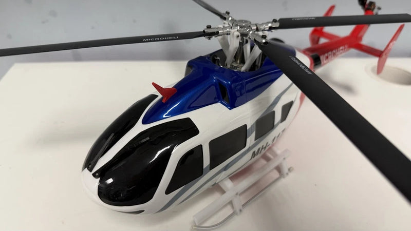Blue, white and black RC helicopter fuselage with landing skids and rotor head