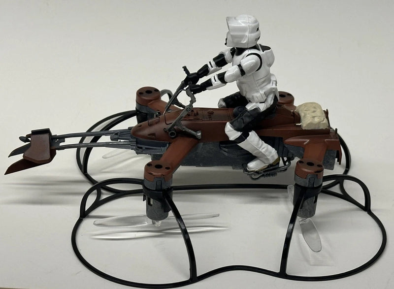 Star Wars speeder bike battling drone with seated white droid and black cables