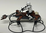 Star Wars speeder bike battling drone with seated white droid and black cables