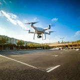Light gray quadcopter drone with camera gimbal, ready for parts set