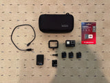 Black GoPro Hero 7 action camera bundle with case, mounts, cable, and microSD card