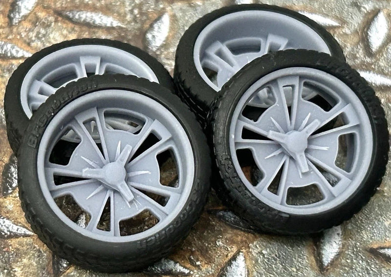 Pair of 1/24 scale model car wheels with black tires and light gray spokes