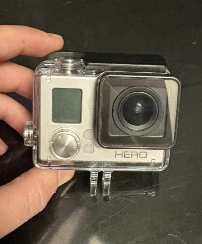 GoPro HERO action camera in clear waterproof housing, silver case with black lens window