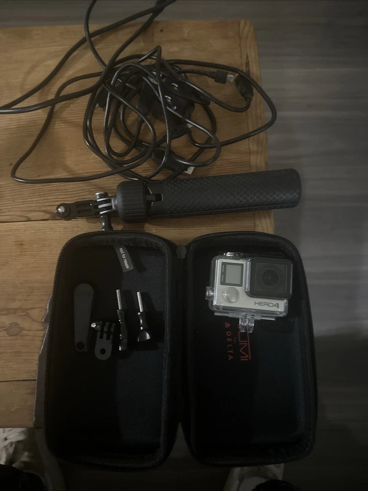 GoPro HERO4 action camera in open case with mounting accessories and SD card