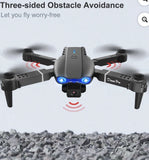 Gray quadcopter drone with dual front camera, blue LED lights and four propellers
