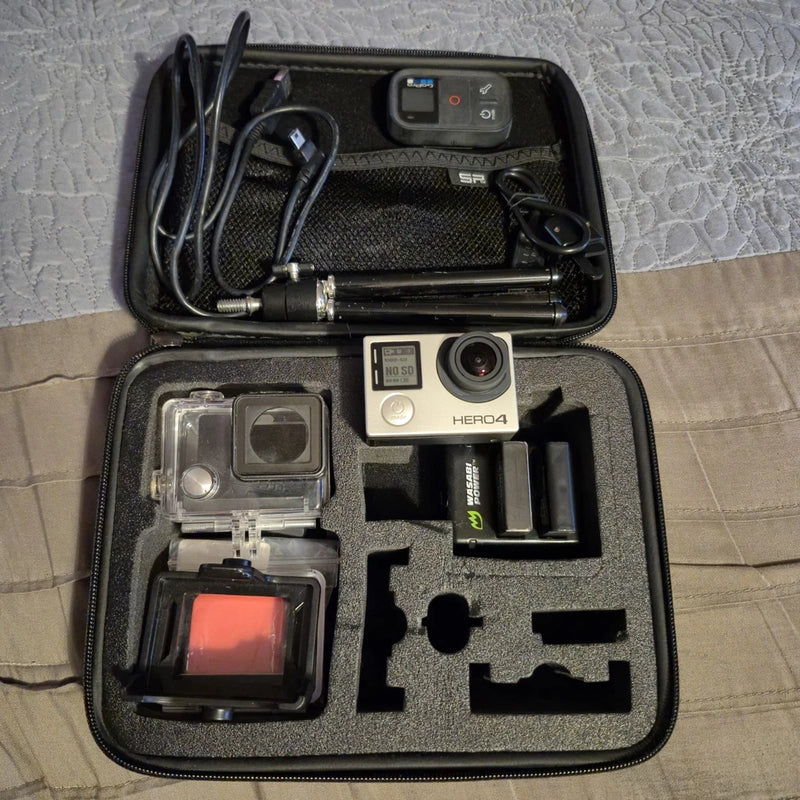 GoPro HERO4 action camera kit in zip case with camera, mounts, and waterproof housing