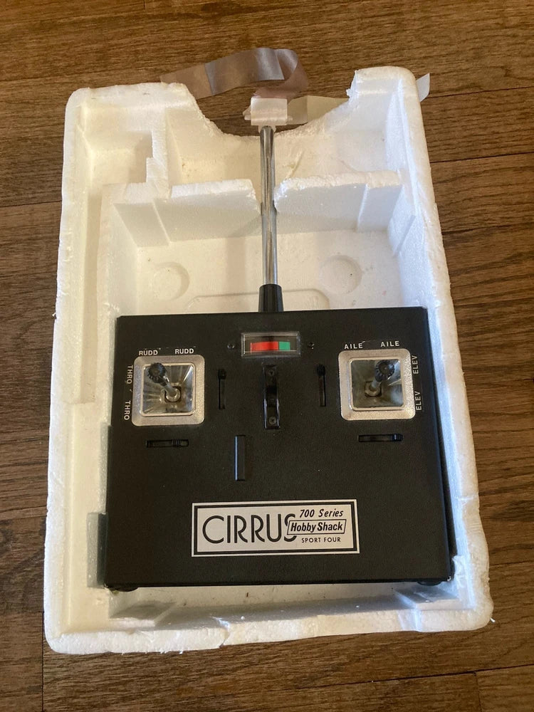 Vintage 4-channel RC transmitter with CIRRUS 700 Series label and antenna, in foam insert