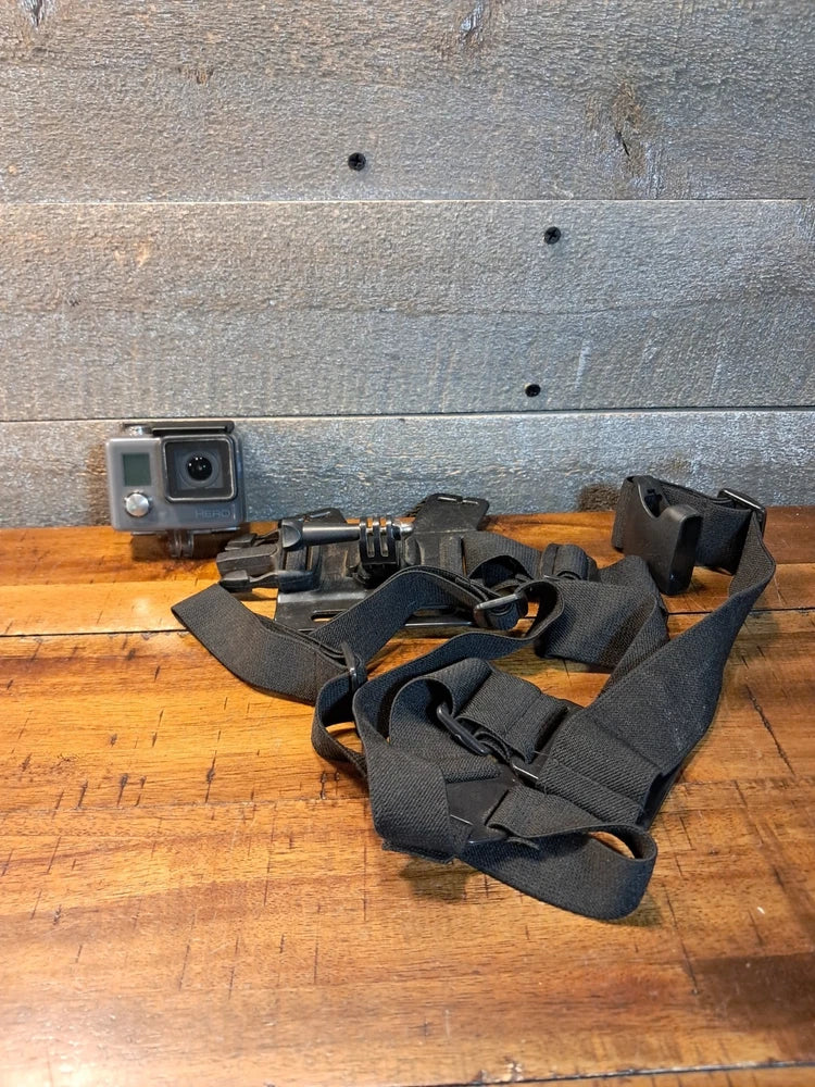 GoPro waterproof HD action camera with black chest-mount straps