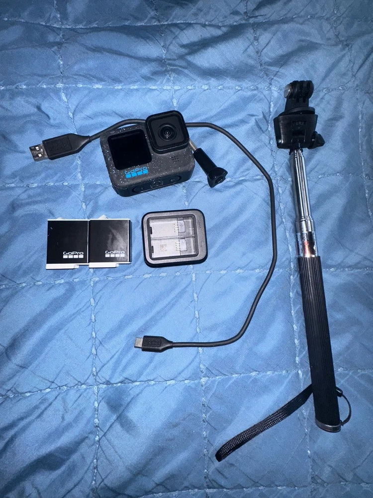 GoPro HERO12 Black action camera with accessories and mounting bracket