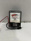Vintage watch battery tester with clear window and two test leads