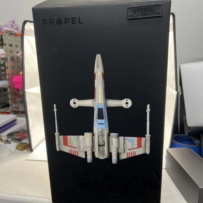 Propel T-65 X-Wing drone model in black display box, front view