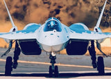 1:72 scale SU-57 model plane with blue canopy, white body, and twin dark engine intakes