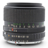 Black camera lens with engraved focus and aperture rings, textured grip